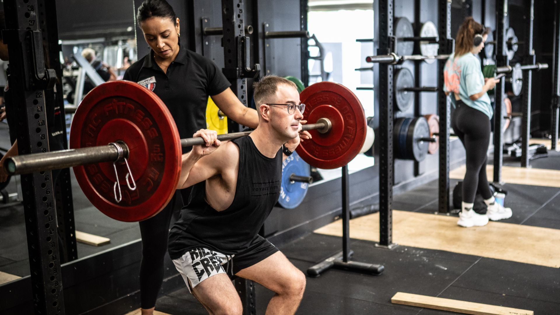 Pat and a trainer lifting weights at the gym